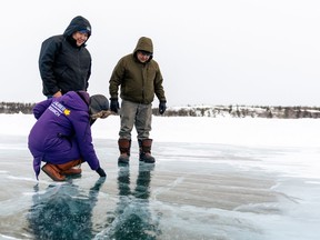Wilfrid Laurier University researcher Homa Kheyrollah Pour examines an ice road with Chase Lockhart, centre, and Rubin Fatt, right, Indigenous guardians from Łutsel Kʼé, NWT, in an undated handout photo.