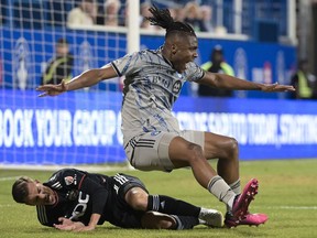 CF Montreal's Chinonso Offor, right, is challenged by D.C. United's Pedro Santos during first half MLS soccer action in Montreal, Saturday, April 15, 2023.