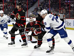 Tampa Bay Lightning centre Ross Colton (79) and Ottawa Senators left wing Egor Sokolov (75) battle for the puck during first period NHL hockey action in Ottawa, on Saturday, April 8, 2023.