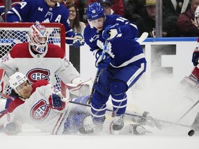 Montreal Canadiens' Johnathan Kovacevic (26) slides to block a shot in front of goaltender Sam Montembeault (35) as Toronto Maple Leafs' Mitchell Marner (16) looks on during first period NHL hockey action in Toronto on Saturday, April 8, 2023.