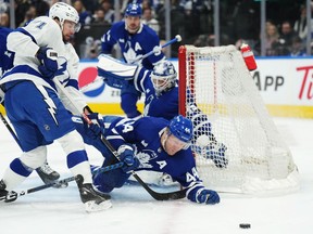 Tampa Bay Lightning forward Anthony Cirelli (71) and Toronto Maple Leafs defenceman Morgan Rielly (44) battle for the puck during first period NHL Stanley Cup playoff hockey action in Toronto, on Tuesday, April 18, 2023.