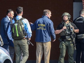 Kentucky Governor Andy Beshear speaks with police deploying at the scene of a mass shooting near Slugger Field baseball stadium in downtown Louisville, Kentucky, U.S. April, 10, 2023.