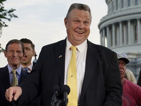 FILE - Sen. Jon Tester, D-Mont., speaks at a news conference alongside Sen. Richard Blumenthal, D-Conn., back left, on Aug. 2, 2022, on Capitol Hill in Washington. Libertarians lined up with Democrats on Friday against a proposal that would effectively block out third party candidates from next year's Montana U.S. Senate election. Republicans are trying to consolidate opposition to incumbent Jon Tester in a race that's pivotal for control of the the Senate.