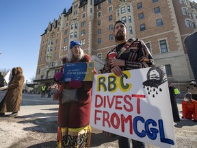 Marchers with signs during a protest against the Royal Bank of Canada's Annual General Meeting at the Delta Bessborough hotel in Saskatoon, Sask., Wednesday, April 5, 2023.
