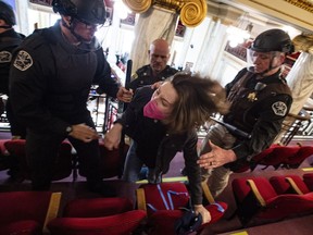 Law enforcement forcibly clear the Montana House of Representatives gallery during a protest on April 24  in the State Capitol in Helena, Mont.