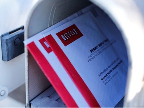 Netflix DVDs return mailers are shown in a mail box in Encinitas, California October 21, 2013.
