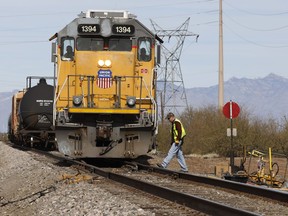 FILE - The crew on a Union Pacific freight train works at a siding area on Jan. 24, 2020, south of Tucson, Ariz. Union Pacific routinely hires private investigators to check out employees' medical leave claims and then fires anyone who happens to leave their house while out on leave, according to a lawsuit filed against the railroad Monday, March 2, 2023.