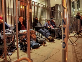 A line for court access is formed outside Manhattan Criminal Court, Tuesday, April 4, 2023, in New York. Former President Donald Trump is facing multiple charges of falsifying business records, including at least one felony offense, in the indictment handed up by a Manhattan grand jury.