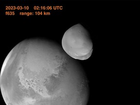 This image provided by the UAE Space Agency shows the planet Mars and its moon, Deimos, in the foreground. The United Arab Emirates' Amal spacecraft - Arabic for Hope - flew within 62 miles of Deimos in March 2023. (UAE Space Agency via AP)