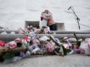 Flowers and candles in memory of those lost to drug poisoning overdoses are visible on the front steps of the Alberta Legislature in Edmonton, Feb. 2022.