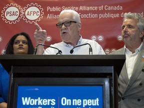 Public Service Alliance of Canada National President Chris Aylward makes a point during a news conference at union headquarters in Ottawa, April 17, 2023.