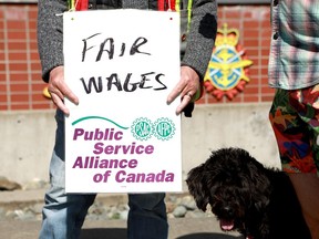 PSAC workers walk the picket line out front of His Majesty's Canadian Dockyard in Esquimalt, B.C., on Friday, April 28, 2023.&ampnbsp;The federal government says an offer extended Friday to striking federal workers is final and describes it as fair and competitive.