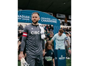 Vancouver FC goalkeeper Callum Irving (left) leads out expansion Vancouver FC in its debut Canadian Premier League game Saturday, April 15, 2023, against Pacific FC at Starlight Stadium in Langford, B.C.