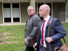 The former head of a Michigan marijuana licensing board Rick Johnson, left, walks with his attorney Nick Dondzila, outside federal court, Tuesday, April 25, 2023, in Grand Rapids, Mich. Johnson pleaded guilty to bribery, acknowledging he accepted at least $110,000 in exchange for approving applications for the lucrative business. Johnson's appearance in federal court was a remarkable fall. Years ago he was a powerful state lawmaker, serving as speaker of the Republican-controlled House from 2001 through 2004.