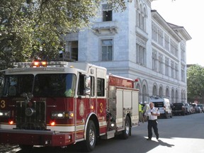 A firetruck sits outside the historic federal courthouse on Tuesday, April 11, 2023, in Savannah, Ga., after part of an upper floor collapsed and injured three construction workers. The U.S. government building, which dates to 1899, has been undergoing extensive renovations for more than a year.