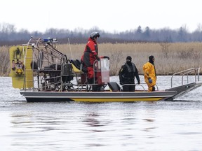 Searchers look for victims Friday, March 31, 2023, after a boat capsized and left eight people dead in Akwesasne, Que. Authorities investigating the disappearance of an Akwesasne man whose boat was found near the bodies of eight migrants pulled from the St. Lawrence River say he was connected to the case.