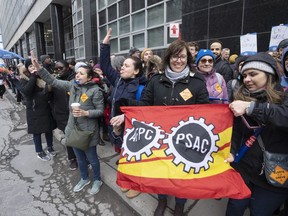 Canada Revenue Agency workers form a picket line as over 150,000 Public Service Alliance of Canada (PSAC) federal employees go on strike across the country, in Montreal, Wednesday, April 19, 2023.