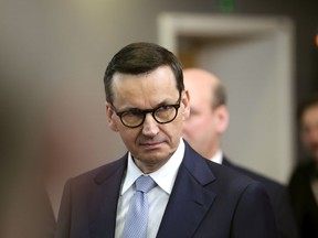 FILE - Poland's Prime Minister Mateusz Morawiecki leaves after an EU summit at the European Council building in Brussels, on March 24, 2023. Morawiecki flew Tuesday, April 11, to the United States for meetings aimed at strengthening the economic and defense cooperation of the two nations.