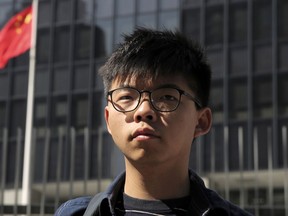 FILE - Pro-democracy activist Joshua Wong stands outside the Legislative Council building in Hong Kong on Nov. 28, 2019. Wong was sentenced Monday, April 17, 2023 to three months in prison for breaching court bans on disclosing personal information about a police officer during 2019 anti-government protests.