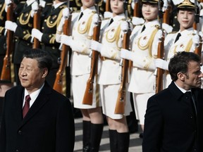 FILE - Chinese President Xi Jinping, left, and France's President Emmanuel Macron review troops during a welcome ceremony at the Great Hall of the People in Beijing, China, April 6, 2023. Russian threats to nuke Ukraine. China's belligerent military moves around rival Taiwan, its growing ties with Moscow and its growing assertiveness throughout Asia. North Korea's unprecedented run of weapons testing and development. The top diplomats from seven of the world's most powerful countries will have plenty to discuss when they gather in the hot spring resort town of Karuizawa starting Sunday, April 16, 2023, for the Group of Seven foreign ministers' summit.