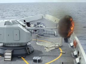 FILE - In this file photo released by China's Xinhua News Agency, an anti-surface gunnery is fired from China's Navy missile frigate Yulin during the "Exercise Maritime Cooperation 2015" by Singapore and Chinese navies in the South China Sea on May 24, 2015. China's military has dispatched a pair of navy ships to take part in joint drills, starting Friday, April 27, 2023, with Singapore's navy and join in a regional maritime security exhibition.