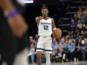 Memphis Grizzlies guard Ja Morant (12) handles the ball in the second half of an NBA basketball game against the Portland Trail Blazers Tuesday, April 4, 2023, in Memphis, Tenn.