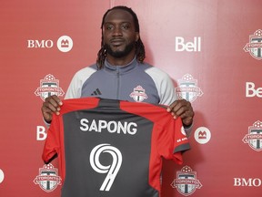 Newly acquired Toronto FC forward C.J. Sapong shows off his jersey Friday, April 28, 2023, at the MLS club's training facility, in Toronto.