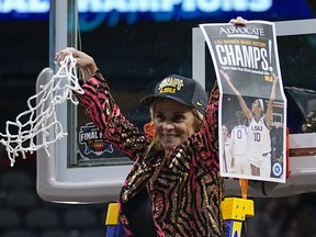 LSU head coach Kim Mulkey celebrates after cutting down the net after the NCAA Women's Final Four championship basketball game against Iowa Sunday, April 2, 2023, in Dallas. LSU won 102-85 to win the championship.