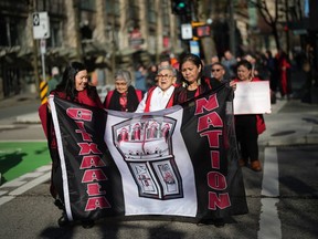 Members of the Gitxaala Nation, including Chief Councillor Linda Innes, front right, march to B.C. Supreme Court in Vancouver, B.C., Monday, April 3, 2023. The British Columbia First Nation challenging the province over an online registry it uses to automatically grant mineral rights is "very hopeful" the B.C. Supreme Court will side with it following a two-week hearing in Vancouver, its chief councillor says.