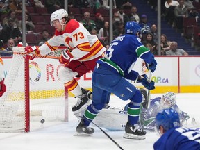 Calgary Flames' Tyler Toffoli (73) scores against Vancouver Canucks goalie Thatcher Demko during the second period of an NHL hockey game in Vancouver, on Friday, March 31, 2023.