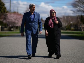 Attia Elserafy, left, and his wife Nadia Baioumy walk together while posing for a photograph near their home, in Richmond, B.C., on Monday, April 3, 2023. The couple were expecting a second lease on life when they escaped Egypt, landing in Vancouver in October 2018. But the Elserfys say their lives are in limbo because the Canada Border Services Agency challenged both of their admissibility as refugees over their ties to a political party outlawed by the Egyptian government.