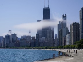 The Chicago city skyline is covered by the fog lifted off Lake Michigan on Aug. 5, 2022, in Chicago. Democrats have chosen Chicago to host their 2024 national convention.