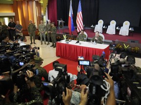 U.S. Marine Corps Major General Eric Austin, right, U.S. Exercise Director Representative, right, with Philippine Army Major General Marvin Licudin, Philippine Exercise Director, answers a question from a reporter after the opening ceremonies of a joint military exercise flag called "Balikatan," a Tagalog word for "shoulder-to-shoulder," at Camp Aguinaldo military headquarters Tuesday, April 11, 2023, in Quezon City, Philippines. The United States and the Philippines on Tuesday launch their largest combat exercises in decades that will involve live-fire drills, including a boat-sinking rocket assault in waters across the South China Sea and the Taiwan Strait that will likely inflame China.