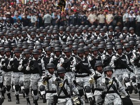 FILE - Members of Mexico's National Guard march in the Independence Day military parade, in the capital's main plaza, the Zocalo, in Mexico City, Sept. 16, 2019. Mexico's Supreme Court ruled April 18, 2023 that the 2022 transfer of the newly created National Guard from civilian to military control was unconstitutional.