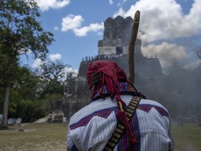 A spiritual guide stands next to an altar during the visit of Taiwan's President Tsai Ing-wen and Guatemala's President Alejandro Giammattei to the Mayan site Tikal, in Peten, Guatemala, Saturday, April 1, 2023. Tsai is in Guatemala for an official three-day visit.