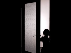 Little female child silhouette opening door into darkness, horror scene, mystic