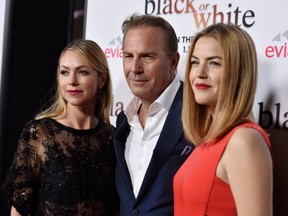 Actor Kevin Costner (C), his wife Christine Baumgartner (L) and daughter actress Lily Costner (R) arrive at the premiere of Relativity Media's "Black Or White" at the Regal Cinemas L.A. Live on January 20, 2015 in Los Angeles, California.