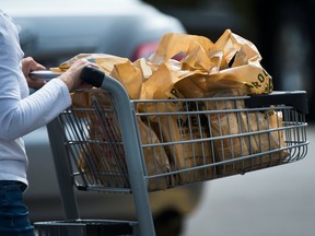 A woman leaves a grocery store using plastic bags in Mississauga, Ont., on Thursday, August 15, 2019. THE CANADIAN PRESS/Nathan Denette