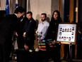 Canadian Prime Minster Justin Trudeau lays a white rose on a table during ceremonies to mark the anniversary of the massacre at Ecole Polytechnique in Montreal, Dec. 6, 2022.