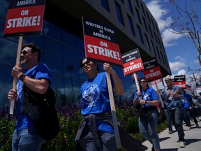 Striking Writers Guild of America workers picket outside the Sunset Bronson Studios building in Los Angeles.
