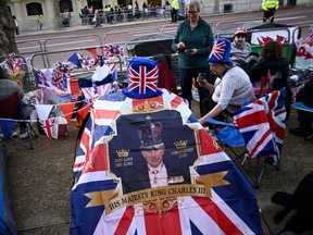 Royal fans gather on The Mall ahead of The Coronation on May 05, 2023 in London, England. The Coronation of King Charles III and The Queen Consort will take place on May 6, part of a three-day celebration. (Photo by Gareth Cattermole/Getty Images)