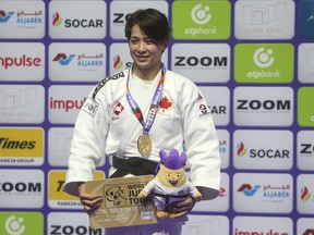 Gold medalist Christa Deguchi of Canada poses during the medal ceremony for the women's 57-kilogram competition at the world judo championships in Doha, Qatar, Tuesday, May 9, 2023. The Japanese-born Deguchi, who lives and trains in Lethbridge, Alta., defeated Haruka Funakubo of Japan in a championship match that lasted less than 90 seconds.