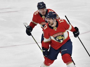 Florida Panthers center Sam Reinhart (13) celebrates scoring the game-winning goal with teammate Anton Lundell during overtime of Game 3 of an NHL hockey Stanley Cup second-round playoff series against the Toronto Maple Leafs, Sunday, May 7, 2023, in Sunrise, Fla.