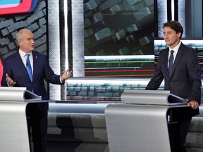 Conservative leader Erin O'Toole speaks to Liberal leader Justin Trudeau during the federal election French-language leaders debate on September 8, 2021.