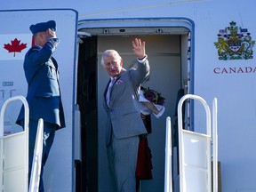 King Charles III waves as he boards a plane to depart Yellowknife to return to the UK in May, 2022. (Reuters)
