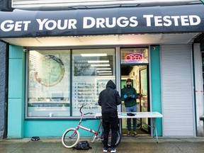 Allen Custance, site manager of Get Your Drugs Tested, helps take samples from a patron in Vancouver, B.C. on Friday April 1, 2022.