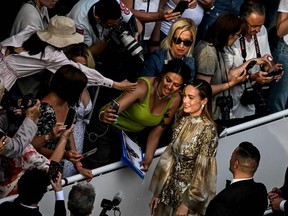 Actress Brie Larson poses for a selfie with a fan during the 76th edition of the Cannes Film Festival.