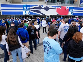 Fans line up to enter the Rogers Centre for the Toronto Blue Jays home opener on May 11.