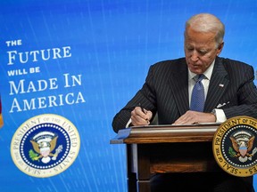 U.S. President Joe Biden signs an executive order aimed at strengthening the federal government's Buy American rules, January 25, 2021.