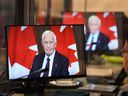 Special Rapporteur David Johnston is seen on the screens of translators as he presents his first report about foreign interference in Canadian elections and government, on May 23, 2023.